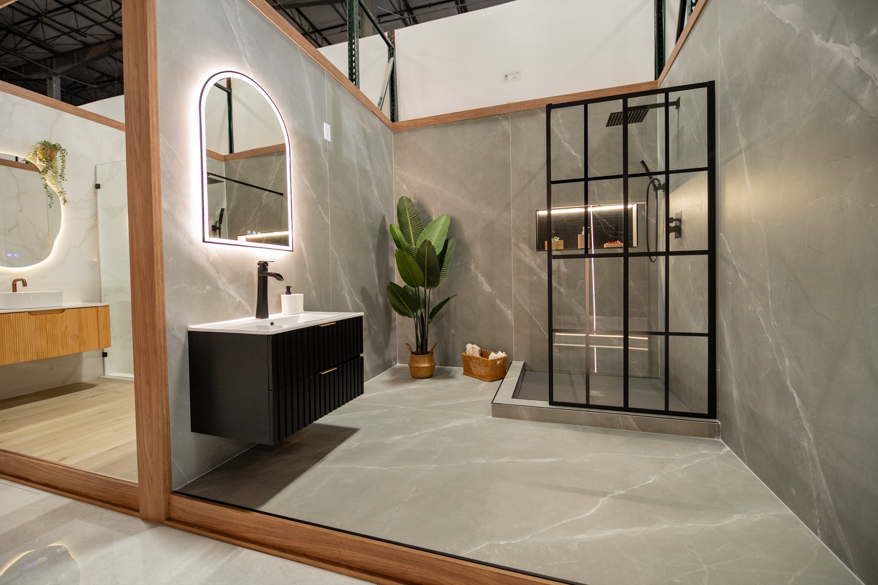 Gray tile bathroom setting with black shower frame