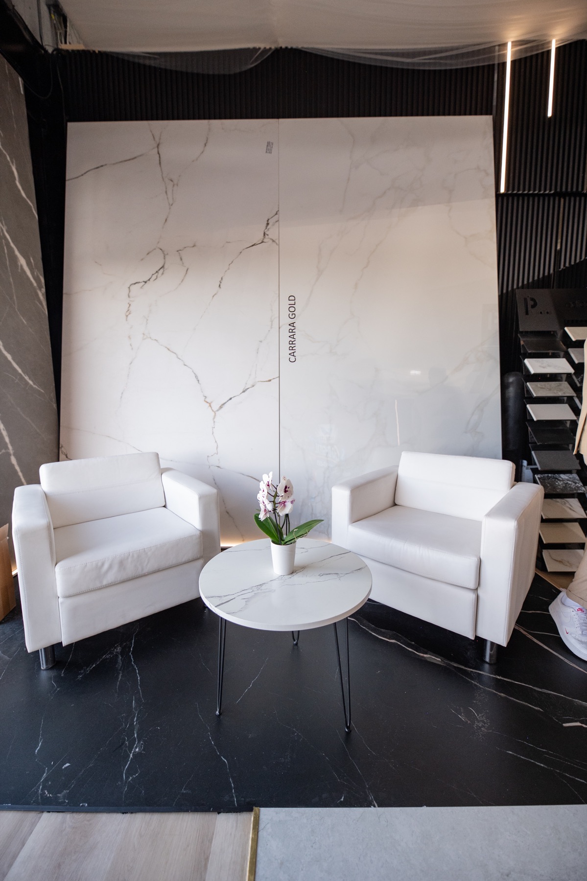 Showroom seating area beside large porcelain slabs